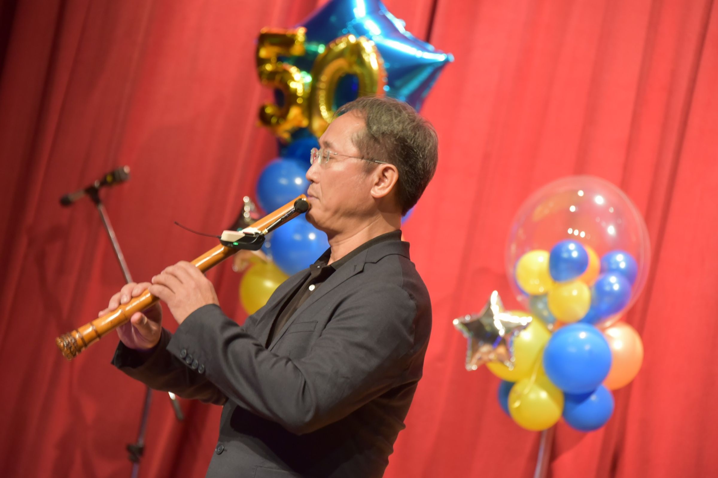 廖慶龍醫師於《秀傳感恩音樂會》演奏洞簫,以樂音實踐療癒。(圖/彰濱秀傳紀念醫院提供)