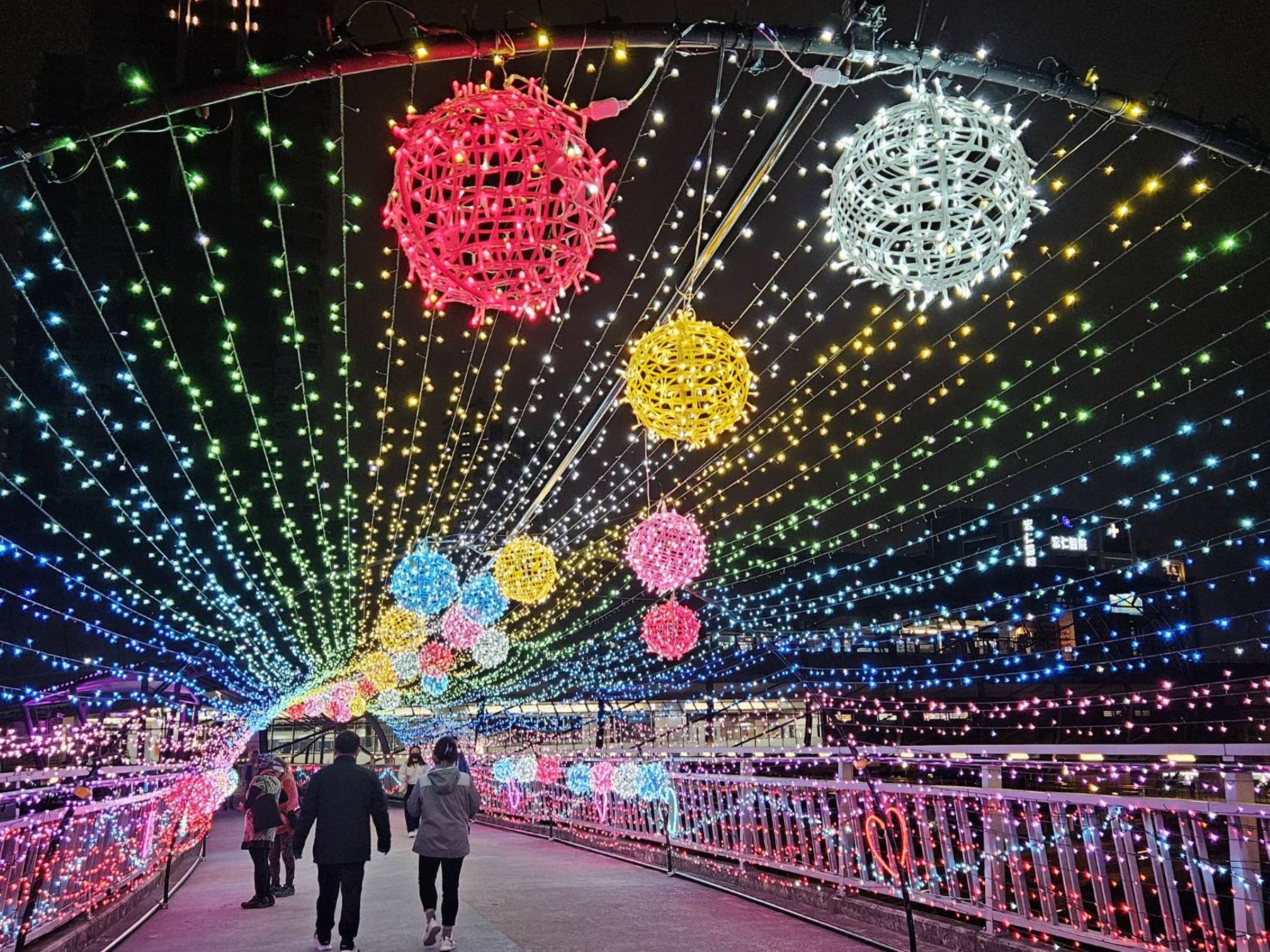 拱型的炫彩光廊中，七彩的星星燈點綴著情人節的夜空。（新北高灘處提供）