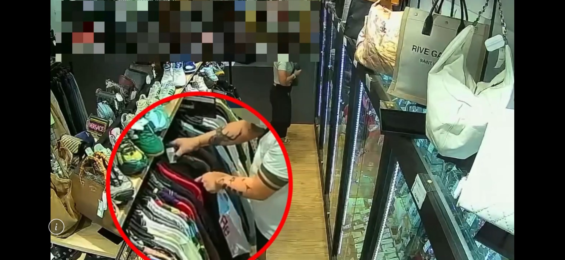 店家監視器拍下陳男手持美工刀伸入衣服貨架，割破精品服飾犯案。（翻攝畫面）