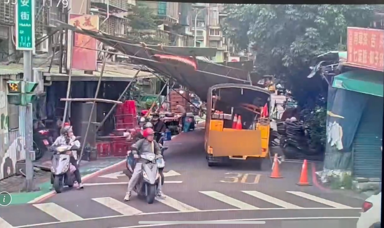 黃男駕駛的中華電信工程車右轉時撞塌宮廟棚架，棚架應聲倒塌。（翻攝畫面）