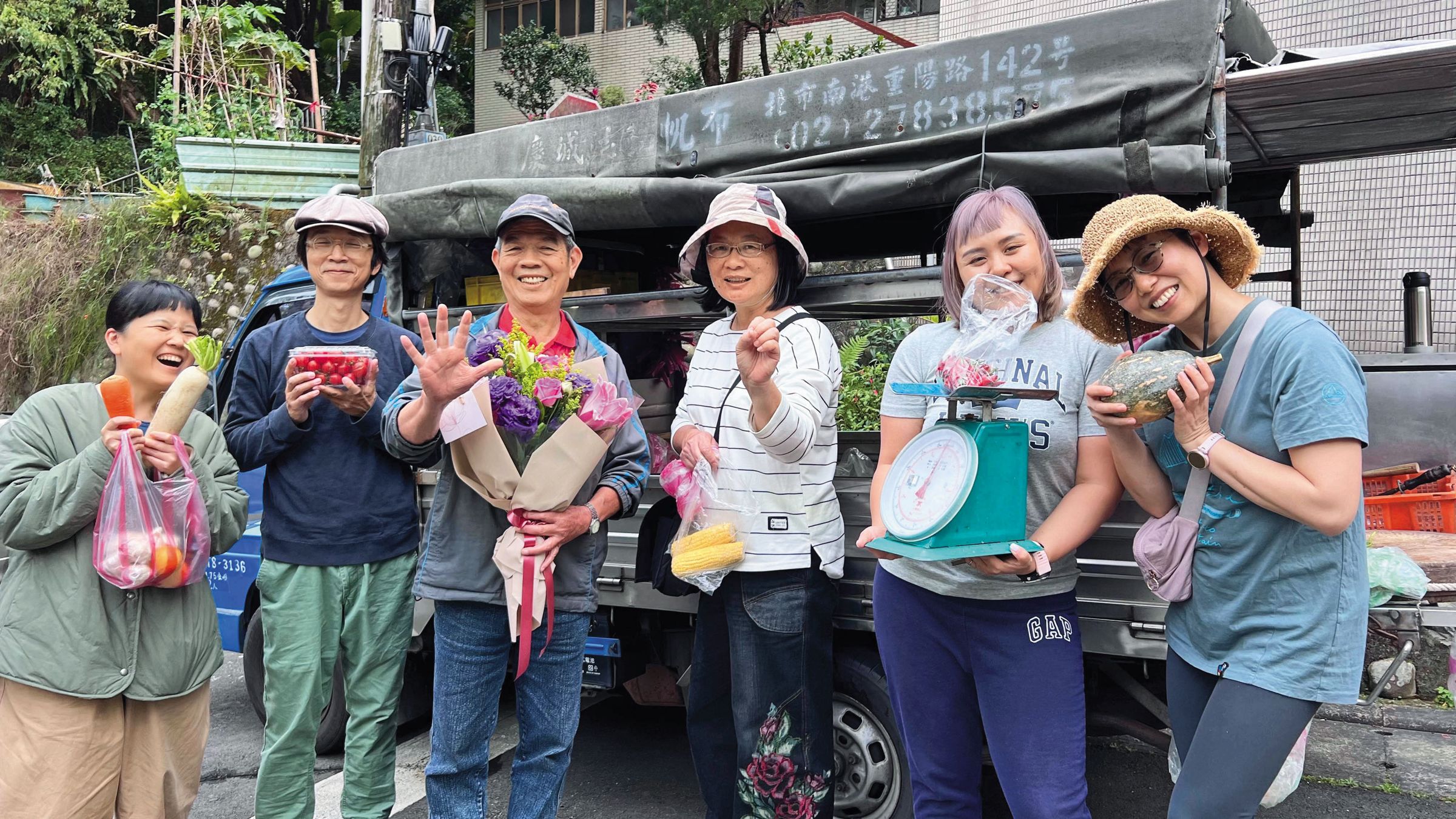 林坤永（左3）3月底退休，居民很捨不得，紛紛來獻花、拍照。（社區居民李諳儀提供）