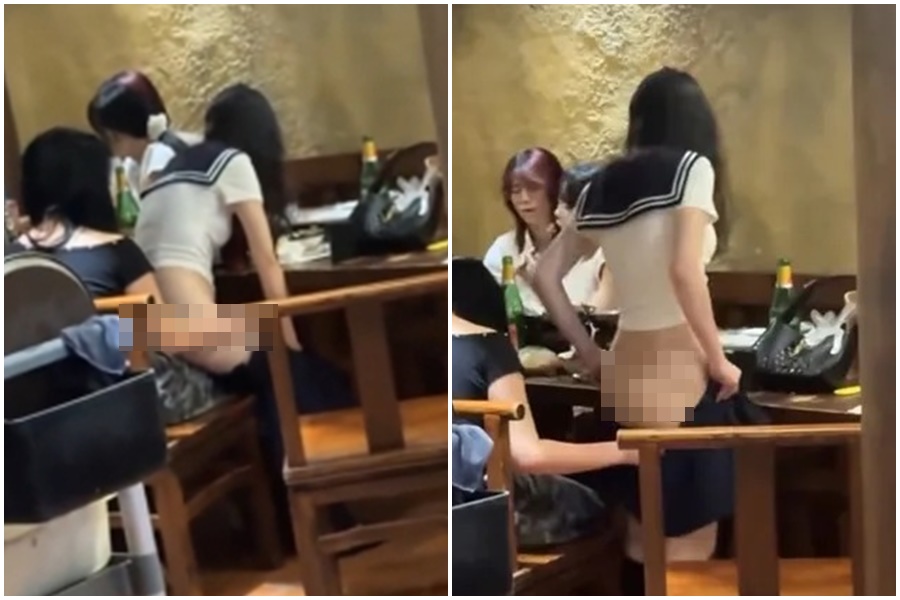 一名穿著水手服的白皙妹，在餐廳吃飯時，突行為怪異，脫褲露出白皙屁桃。（翻攝自微博）