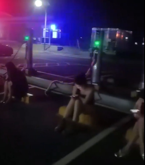 一群正妹逐一坐在電動車停車格，等待上門充電的車主選擇性交易。（翻攝X@JenniferZeng15）
