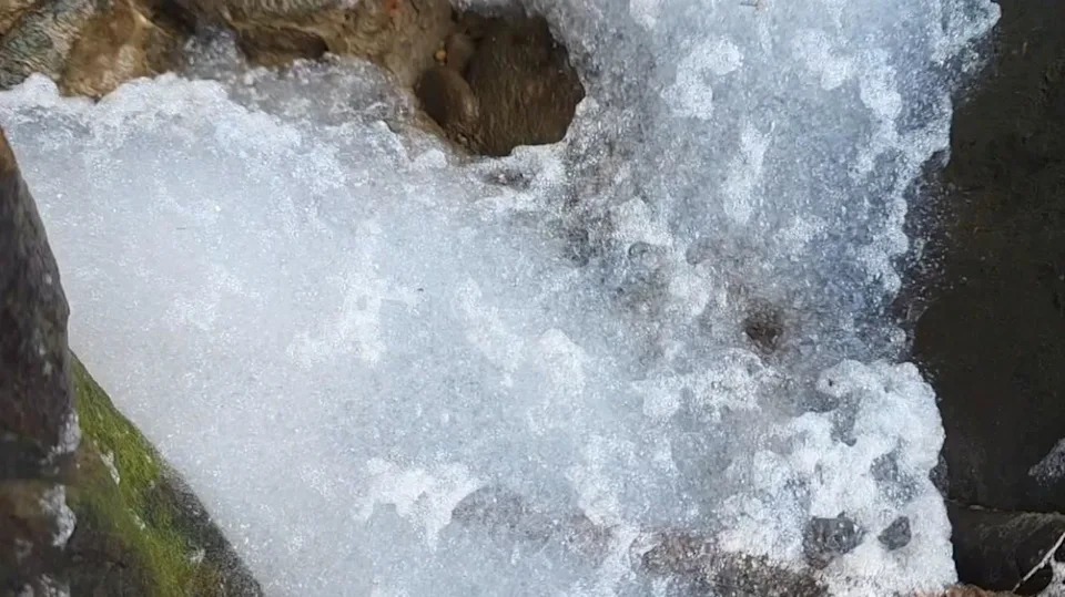今日上午位於上游處的暖暖溪卻突然出現許多白色不明泡沫。（翻攝畫面）